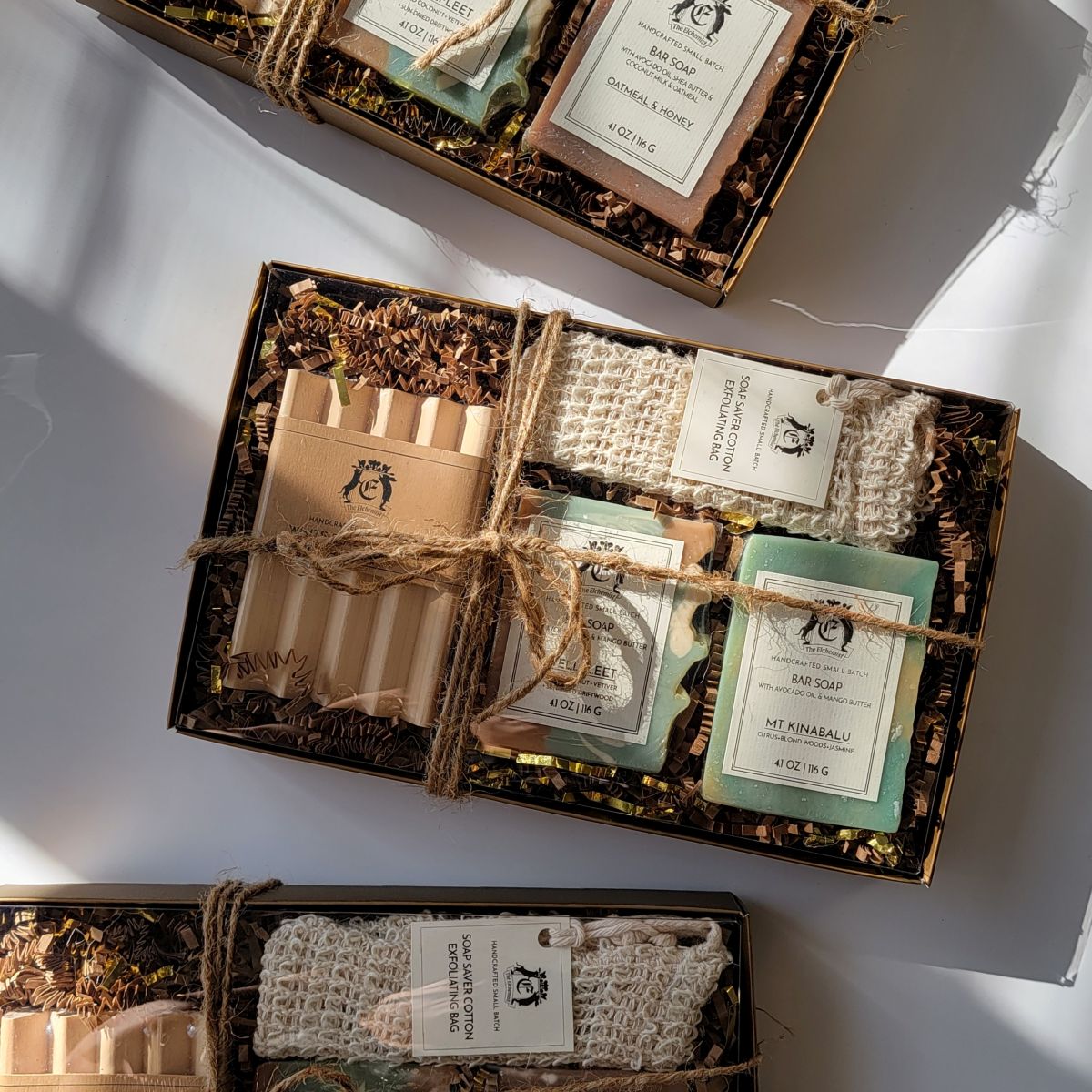 The Elchemist Discovery Soap Set with two artisanal bar soaps, wooden soap dish and soap saver bag